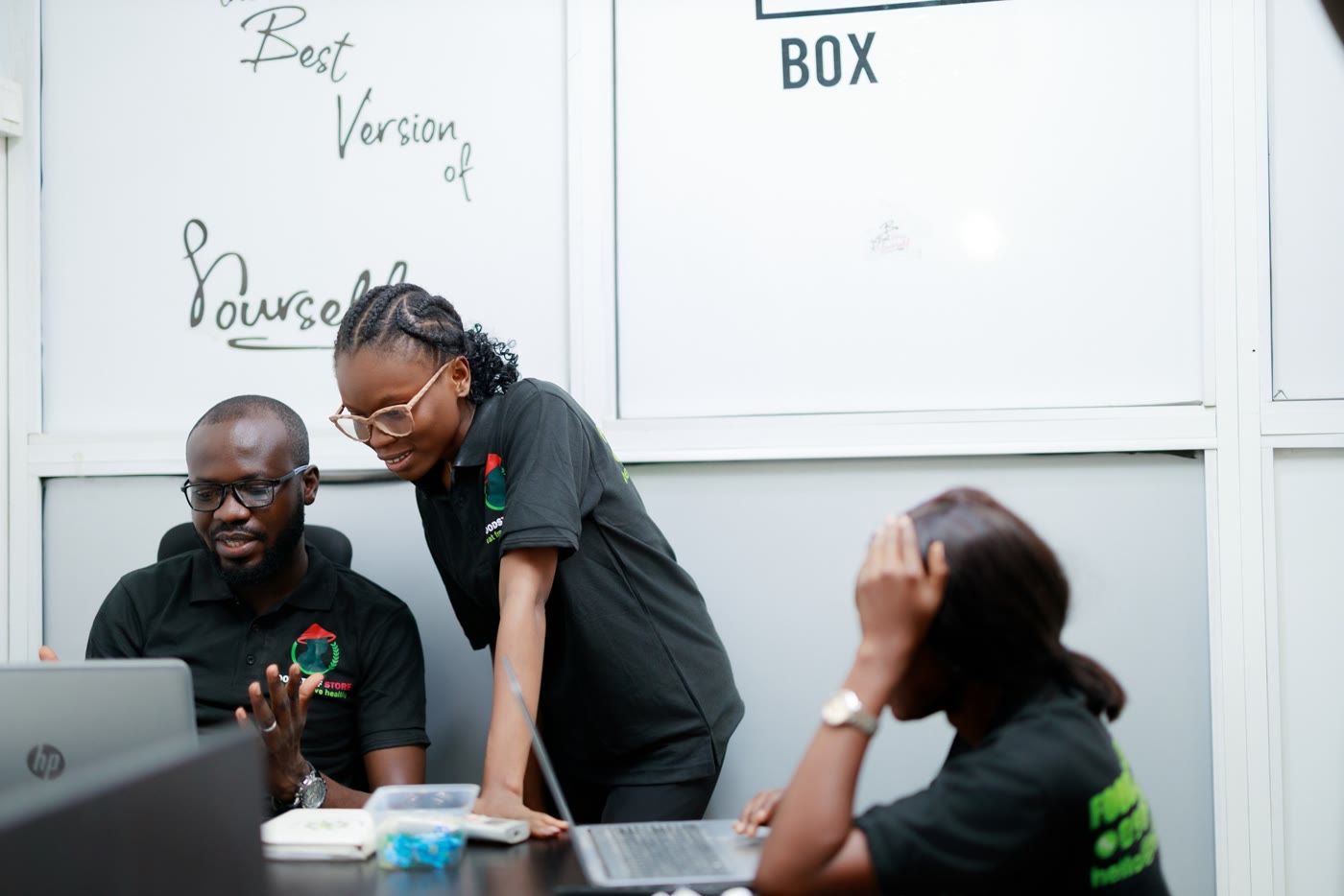 Foodstuff Store team members working together at laptops in the office